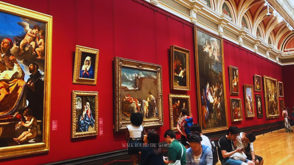 Visitors viewing paintings inside National Gallery London