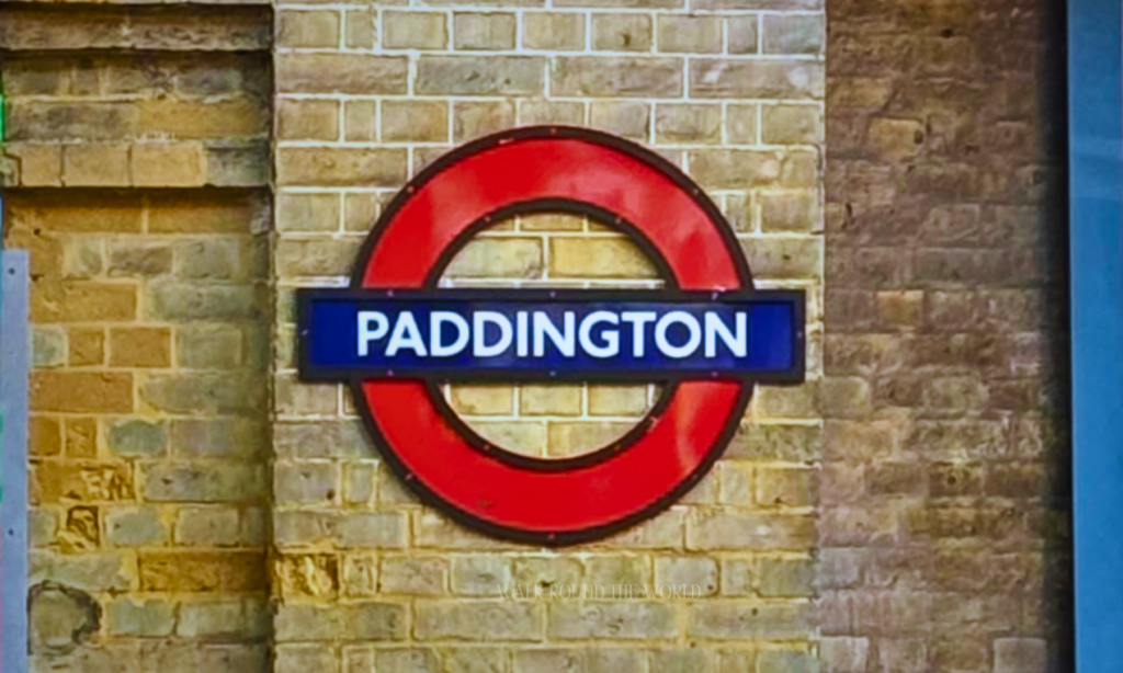 Paddington Underground roundel sign on brick wall in London
