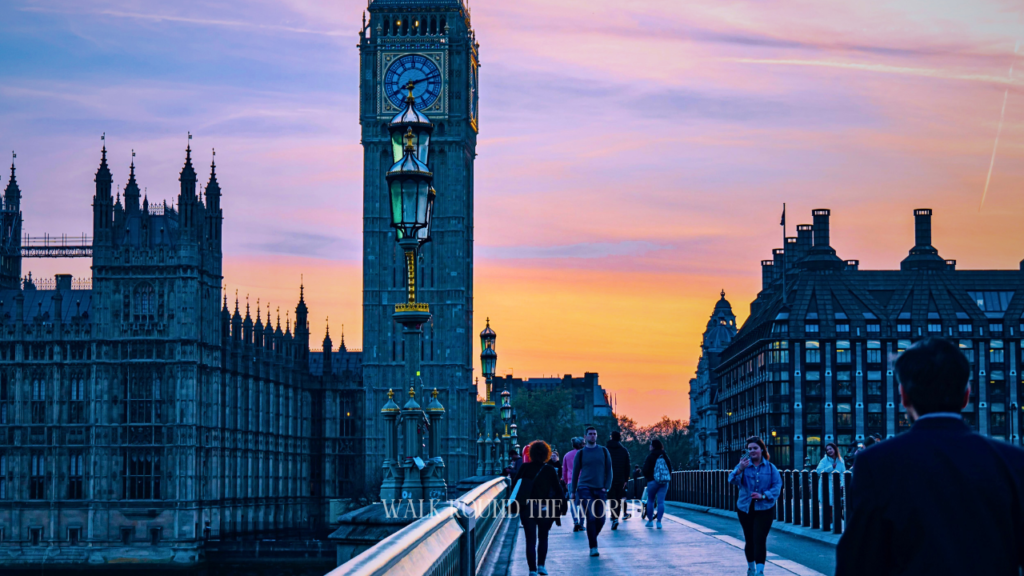 Tourists walking across Westminster Bridge London during the dusk