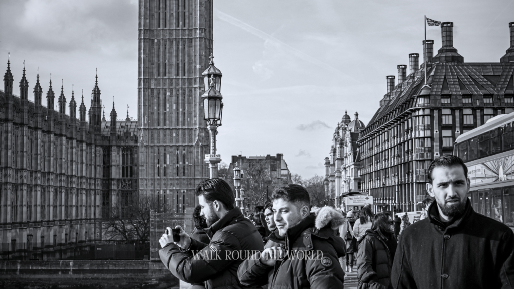 Old photos of people standing over Westminster Bridge London on a sunny day