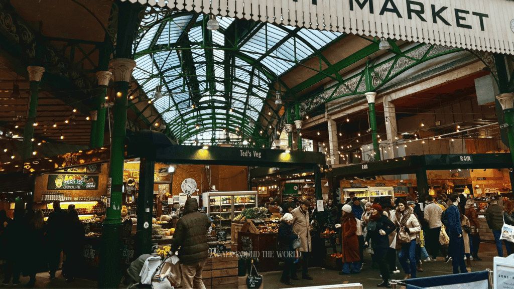 Borough Market entrance in Southwark London with visitors exploring the historic food market