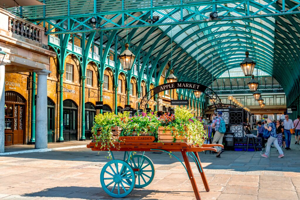 “Covent Garden Apple Market in London with street performers, boutique shops, and lively pedestrian area in Central London”