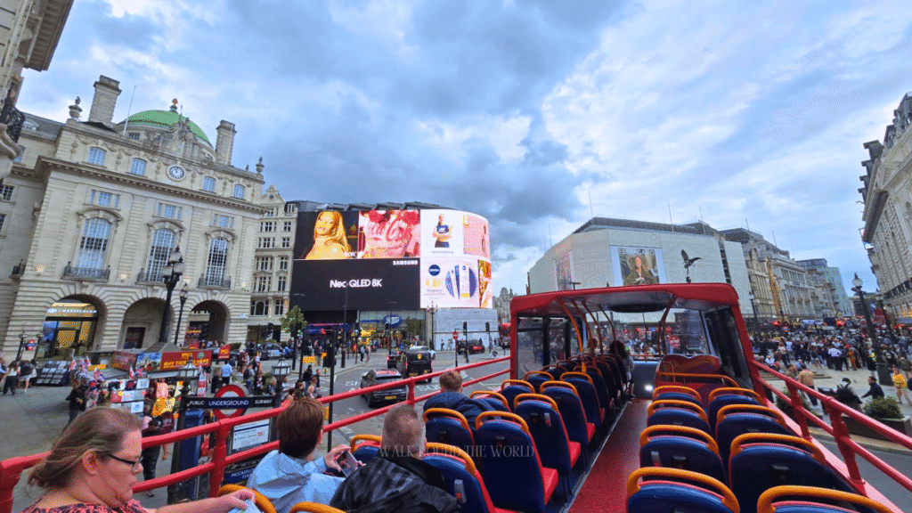 Red hop on hop off sightseeing bus in London during summer