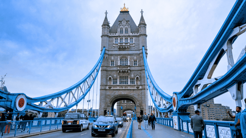People walking across Tower Bridge during summer in London