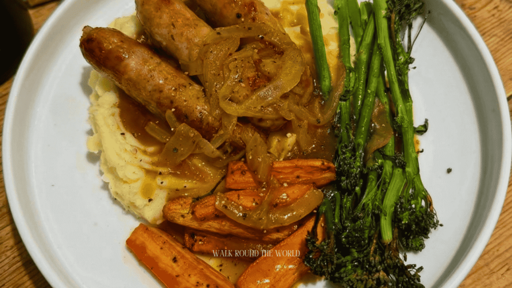 Traditional bangers and mash served in a central London pub with creamy mashed potatoes, onion gravy and classic British pub atmosphere.