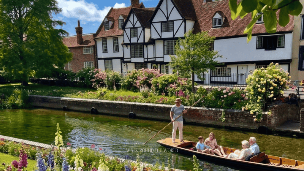 Tourists enjoying a punting boat ride on the River Stour beside historic Tudor buildings in Canterbury during a day trip from London.