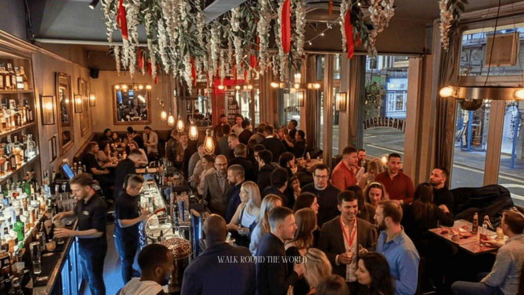 Traditional London pub in Central London on a warm summer evening with outdoor seating, glowing lights and visitors enjoying British pub culture