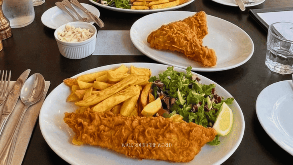 Traditional fish and chips served at a historic Central London pub with crispy battered cod, chunky chips, mushy peas and tartar sauce.