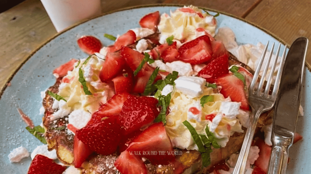 Traditional Eton Mess dessert served in a London pub with fresh strawberries, whipped cream and crushed meringue during summer.