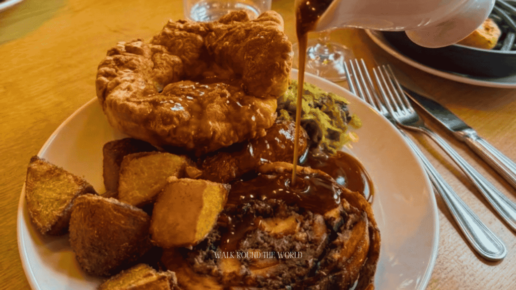 Traditional Sunday Roast served in a historic London pub with roast beef, Yorkshire pudding, roast potatoes, seasonal vegetables and rich gravy.