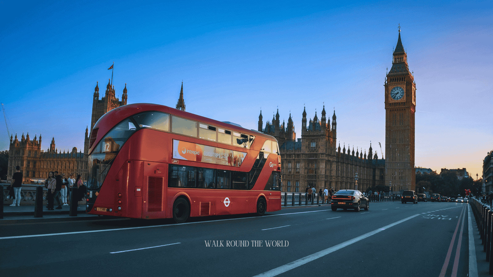 Red London bus passing Big Ben and the Houses of Parliament in Westminster