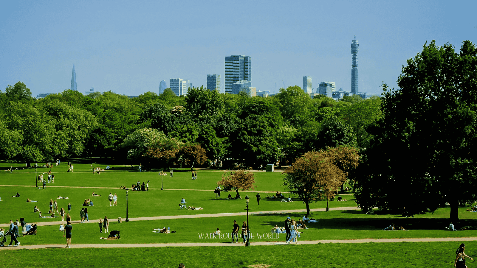 People relaxing and enjoying a sunny afternoon at Primrose Hill in London