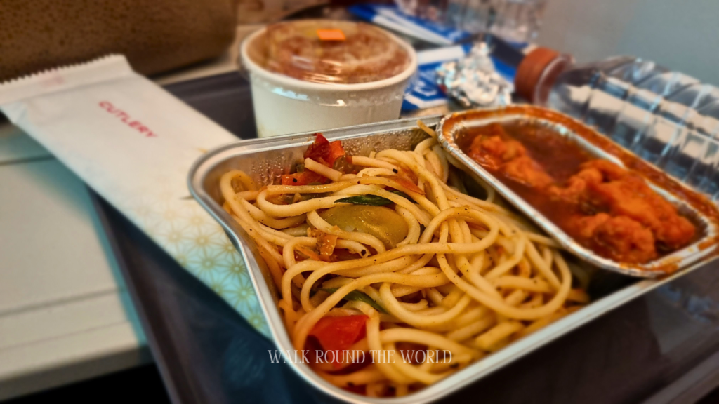 Prebooked Hindu Non-Veg meal on Air India flight AI 133 economy class featuring noodles with chicken item in gravy